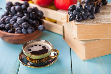 coffee in a cup, grapes and apples on a table, selective focus, copy space