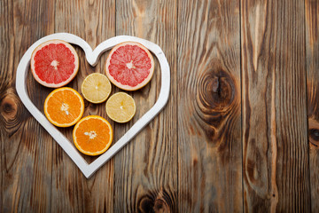 Citrus fruit in a heart on  wooden background