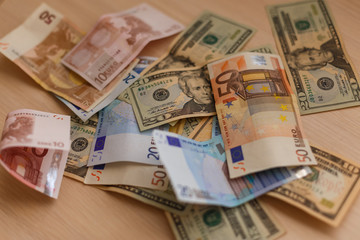 Cash on table isolated: dollars, euro broken money All in mess, global crisis concept