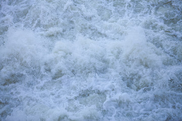 Water flowing from the open sluice gates of dam.