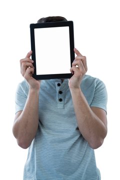 Man holding a digital tablet in front of his face