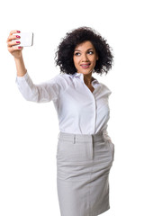 Beautiful brunette woman in classic white shirt and skirt make selfie on the phone.