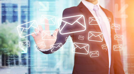 Businessman touching technology interface with email icons