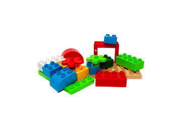 Obraz premium Colorful plastic building bricks on a white background, place fo