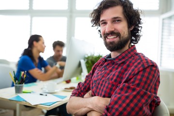 Portrait of smiling business executive with arms crossed