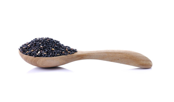 black sesame in spoon wood on white background