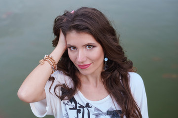 young beautiful woman on the background of water in the Park