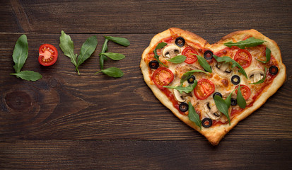 Valentines day pizza in heart shape with inscription love on dark rustic wooden background. - 133489315