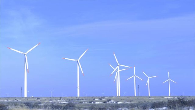 Wind Turbines generating electricity on blue sky