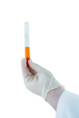 Doctor hand wearing medical gloves holding a test tube