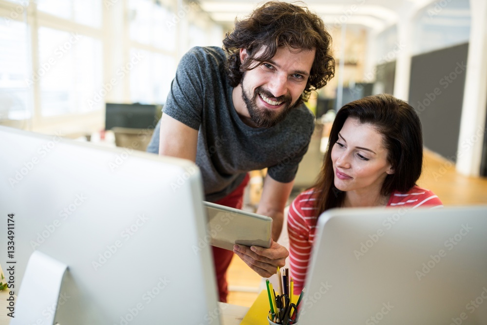 Poster graphic designers working over computer