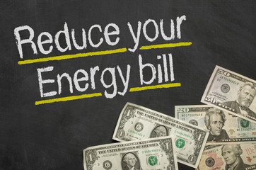 Text on blackboard with money - Reduce your energy bill