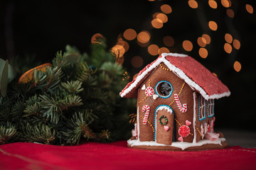 Sweet gingerbread house and Christmas tree branch