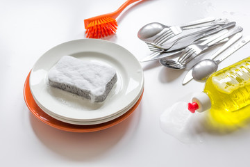 concept of washing dishes on white background top view