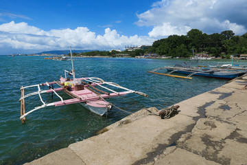 Pink Fishing Boat Docked in Local Village