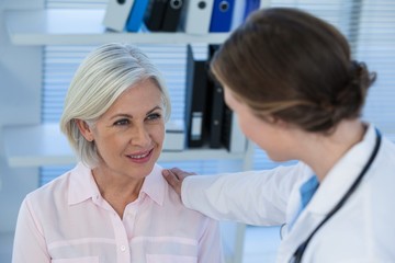 Close-up of female doctor consoling a patient