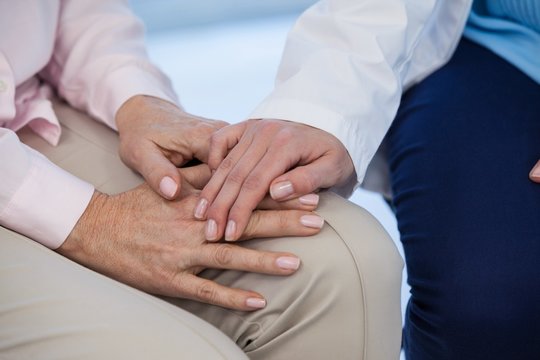Close-up of female doctor consoling a patient