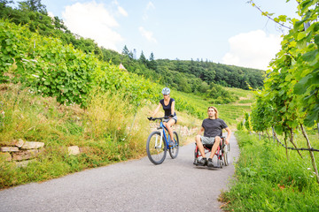 Young Couple In Wheelchair Enjoying Time Outdoors