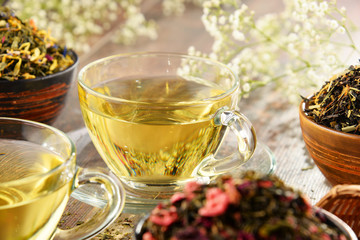 Composition with cup of tea and bowls of tea leaves