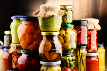 Jars with variety of pickled vegetables.