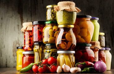 Jars with variety of pickled vegetables.