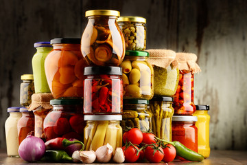 Jars with variety of pickled vegetables.
