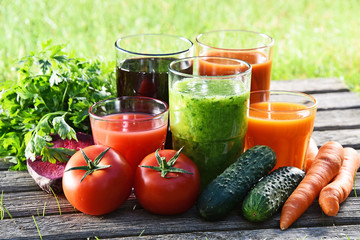Glasses with fresh organic detox juices in the garden
