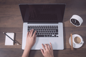 Working place, Laptop, Memo, Clock, Coffee cup on wooden background.