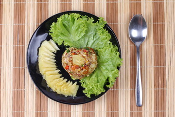 Fried brown rice with pineapple in yellow curry powder.