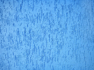 Detail of a textured, blue exterior wall