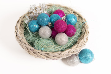 Christmas balls lying in a basket in the nest