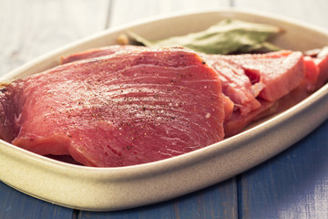 raw tuna on dish on white background