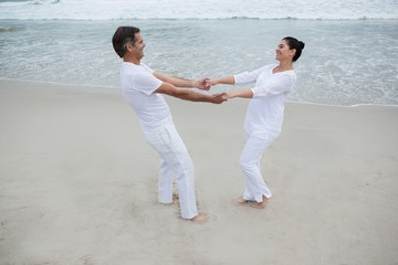 Romantic couple holding hands on beach