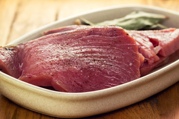raw tuna on dish on white background