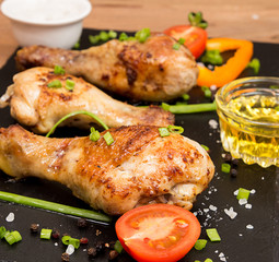 Fried chicken legs garnish cherry tomato and bunch-onion
