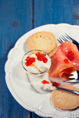 smoked salmon with sauce and caviar on plate