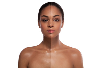 portrait of a african woman with a half of a face with a whitening skin over white background