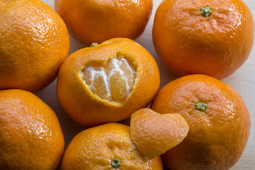 Sweet orange mandarins and one with a hole in form of heart