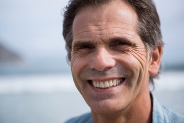 Close-up of smiling man on beach
