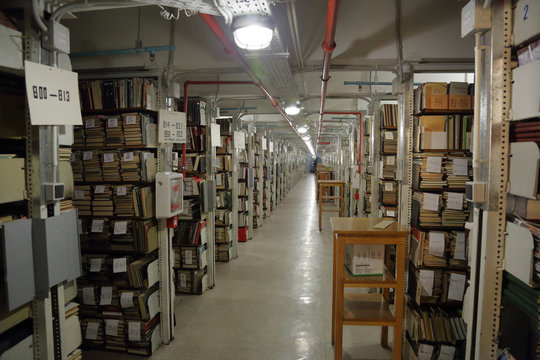 Long corridor with iron shelves with books