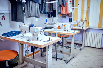 Seamstress inserts thread in old sewing machine