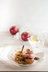 Naklejka na ściany i meble Baked apples stuffed with walnuts and honey on white plate