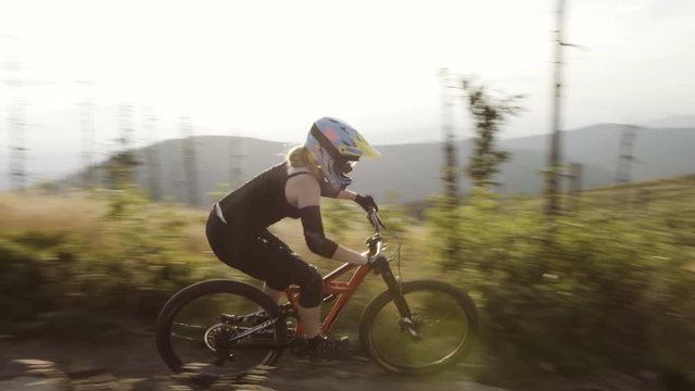 Woman riding MTB mountain bike single line in Mountains