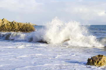 Waves crashing against rocks on killiney beach,county Dublin,Ireland.