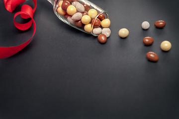 Glass with chocolate dragees for Valentines Day