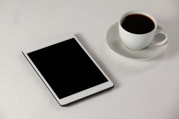Fototapeta na wymiar Digital tablet and cup of coffee