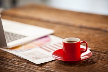 Red coffee cup on wooden table