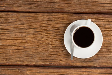 Obraz na płótnie Canvas Cup of coffee on wooden table