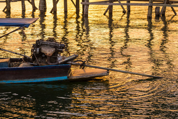 Long tail boat motor engine with sunset background
