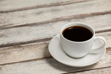 Cup of coffee on wooden table